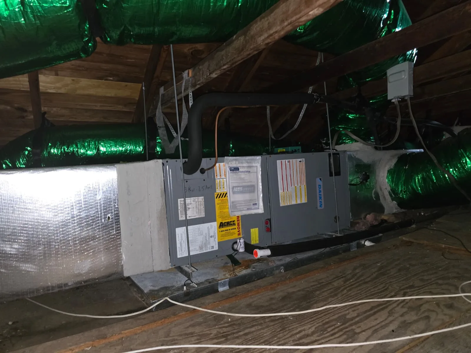 Residential air handler installed in an attic as part of HVAC system work