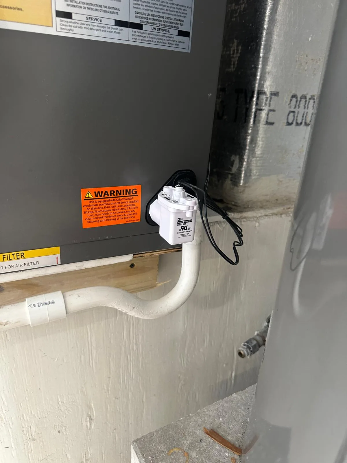 Air handler condensate drain and float switch checked during AC maintenance