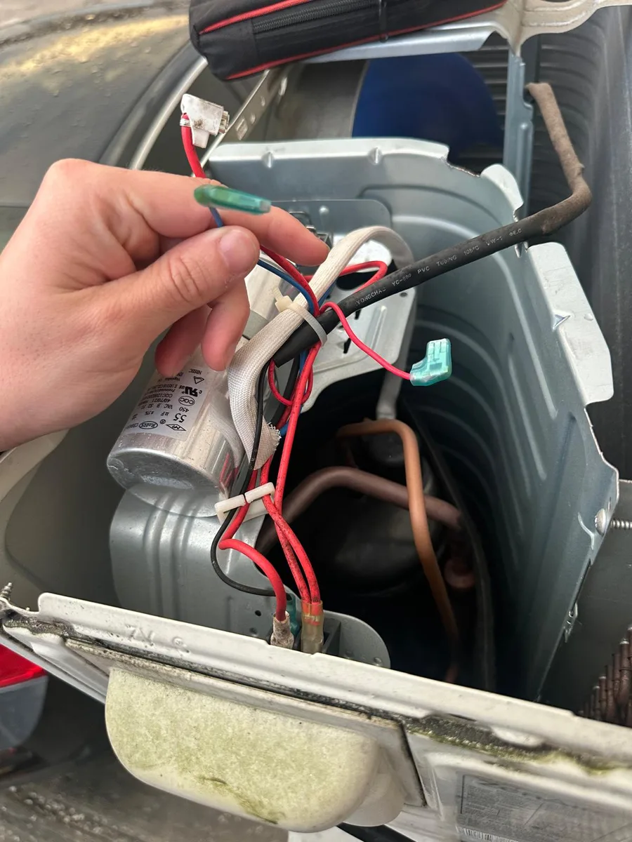 HVAC capacitor and electrical wiring inspected during residential AC repair