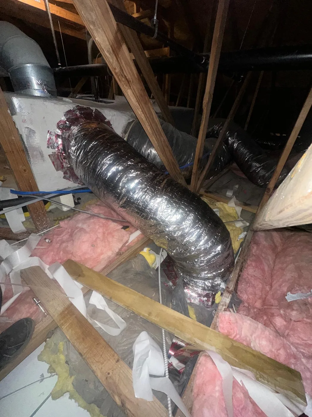 Existing residential attic ductwork being evaluated for duct repair or replacement