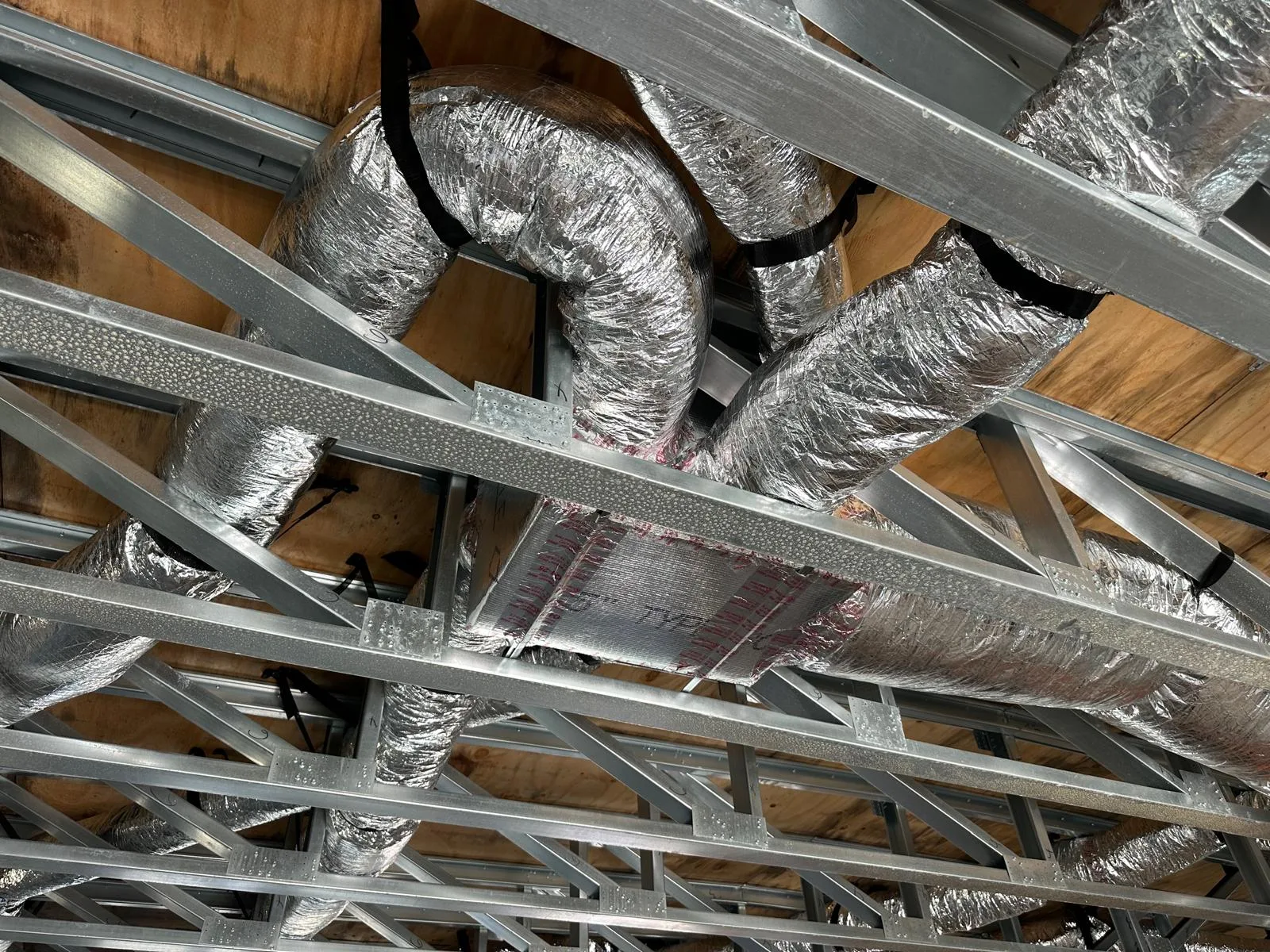 New insulated flexible HVAC ductwork installed in a residential ceiling space